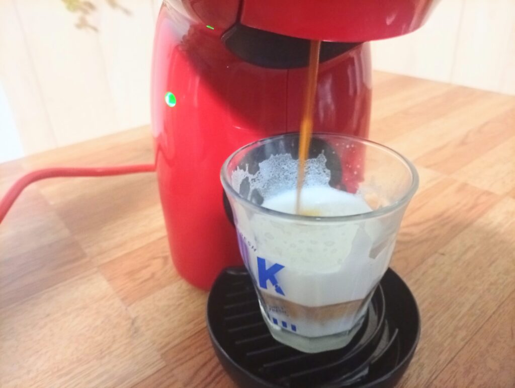 ミルクの上へキャラメルマキアートのコーヒーを抽出し始めた様子